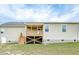 The home's back exterior features a raised deck and stairs to access the yard at 212 Placid Pond Dr, Broadway, NC 27505