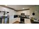 Modern kitchen featuring stainless steel appliances, sleek black countertops, and ample white cabinetry at 212 Placid Pond Dr, Broadway, NC 27505