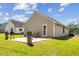 Back exterior features a small patio area and a well-maintained lawn with ample outdoor space at 2308 Buffalo Way, Durham, NC 27704