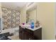 Bathroom featuring a shower-tub combo, single vanity, and tiled floor at 2308 Buffalo Way, Durham, NC 27704