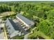 An aerial view of the townhomes nestled in a lush community with mature trees, pond and manicured lawns at 2316 Apex Peakway, Apex, NC 27502