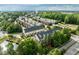 An aerial view of the townhome community, showcasing the lush landscaping, pond and manicured lawns at 2316 Apex Peakway, Apex, NC 27502