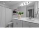 The bathroom is bright with white cabinets, modern lighting, and a framed mirror over the sink at 2316 Apex Peakway, Apex, NC 27502