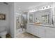 This bathroom features a granite-topped double vanity, a glass shower, and lots of natural light at 2316 Apex Peakway, Apex, NC 27502