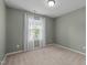 Bedroom features soft walls, carpet flooring, a window with curtains and baseboard molding at 2316 Apex Peakway, Apex, NC 27502