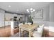 Open-concept dining room view showing chandelier and kitchen in the background at 2316 Apex Peakway, Apex, NC 27502