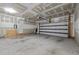 Unfinished garage interior features concrete floor, paneled garage door and unfinished walls at 2316 Apex Peakway, Apex, NC 27502