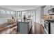 Modern kitchen with island, granite countertops, stainless steel appliances, and bright dining area at 2316 Apex Peakway, Apex, NC 27502