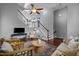 Spacious living room with staircase, hardwood floors, ceiling fan and stylish furnishings at 2316 Apex Peakway, Apex, NC 27502