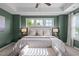 This primary bedroom is illuminated by bright windows and features a bench and a plush king-size bed at 2316 Apex Peakway, Apex, NC 27502