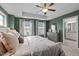 Relax in this bedroom with a ceiling fan, natural light, and an en-suite bathroom visible through the door at 2316 Apex Peakway, Apex, NC 27502