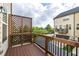 Private covered balcony with wood flooring overlooking the trees and neighborhood at 2316 Apex Peakway, Apex, NC 27502