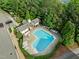 Aerial view of a community pool with sun loungers, picnic tables, and lush greenery around at 2316 Apex Peakway, Apex, NC 27502