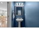 Stylish powder room with pedestal sink, elegant mirror, and a sleek, modern design at 2316 Apex Peakway, Apex, NC 27502