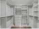 Organize your wardrobe in this walk-in closet with custom shelving, drawers, and ample storage at 2316 Apex Peakway, Apex, NC 27502