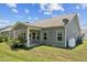 Spacious backyard with covered patio, green grass and gray siding on home at 233 Theys Mill Way, Fuquay Varina, NC 27526