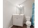 Bathroom featuring a white vanity, square mirror, toilet and shower with decorative curtain at 233 Theys Mill Way, Fuquay Varina, NC 27526