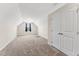 Cozy carpeted bedroom featuring neutral walls, a window, and double door closet at 233 Theys Mill Way, Fuquay Varina, NC 27526