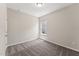 Bedroom featuring neutral carpet, white trim, and a single window at 233 Theys Mill Way, Fuquay Varina, NC 27526