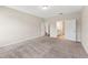 Spacious bedroom featuring plush carpet and white doors leading to other rooms at 233 Theys Mill Way, Fuquay Varina, NC 27526