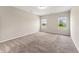 Bedroom featuring neutral carpet, a ceiling light, and two windows at 233 Theys Mill Way, Fuquay Varina, NC 27526