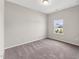 Bedroom featuring neutral carpet, white trim, and a single window at 233 Theys Mill Way, Fuquay Varina, NC 27526