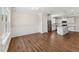 Eat in kitchen adjacent to dining room features stainless appliances, granite countertops, and white shaker cabinets at 233 Theys Mill Way, Fuquay Varina, NC 27526