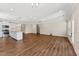 Open floor plan featuring a kitchen with stainless appliances, shaker cabinets and a granite island overlooking living room at 233 Theys Mill Way, Fuquay Varina, NC 27526