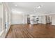 Spacious living room adjacent to the kitchen features stylish wood flooring and a bright, open floor plan at 233 Theys Mill Way, Fuquay Varina, NC 27526