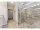 Tiled walk-in shower with glass door and handicap bars in a modern bathroom at 233 Theys Mill Way, Fuquay Varina, NC 27526