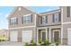 Charming townhome showcasing gray siding, white trim, and an attached garage at 239 Moyer Dr, Graham, NC 27253