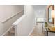 Bright hallway featuring wood floors and stairway to the upper level at 239 Moyer Dr, Graham, NC 27253