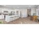 Modern kitchen with a breakfast bar, white cabinets, stainless appliances, and open floorplan at 239 Moyer Dr, Graham, NC 27253
