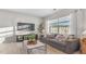 Bright living room with a comfortable sofa and a view through large windows at 239 Moyer Dr, Graham, NC 27253