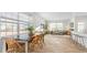 Open-concept living area with dining space, stylish furnishings, and large windows at 239 Moyer Dr, Graham, NC 27253