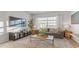 Bright living room with a comfortable sofa and a view through large windows at 239 Moyer Dr, Graham, NC 27253