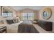 Stylish main bedroom featuring modern furnishings and natural light from a window at 239 Moyer Dr, Graham, NC 27253