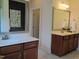 Bathroom with double vanities, elegant mirrors, and stylish fixtures, offering ample space and storage at 243 Nortwick Rd, Rolesville, NC 27571