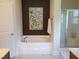 Bathroom highlighting a soaking tub with a sleek design and a separate glass-enclosed shower at 243 Nortwick Rd, Rolesville, NC 27571