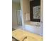 Bright bathroom with soaking tub, shower and neutral-toned walls and stylish botanical art at 243 Nortwick Rd, Rolesville, NC 27571