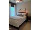 Comfortable bedroom featuring a ceiling fan, bedside lamps, and a window for natural light at 243 Nortwick Rd, Rolesville, NC 27571