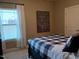 Bedroom filled with natural light, featuring a comfortable bed and charming wall decor at 243 Nortwick Rd, Rolesville, NC 27571
