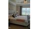 Bedroom showcasing a decorative ceiling fan, a large window, and neutral toned decor and furnishings at 243 Nortwick Rd, Rolesville, NC 27571