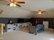 Well-lit bonus room with ample storage, cozy seating and neutral carpeting at 243 Nortwick Rd, Rolesville, NC 27571