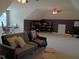 Versatile bonus room with cozy seating and neutral carpeting at 243 Nortwick Rd, Rolesville, NC 27571