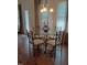 Sunlit dining area features wood floors and a modern chandelier at 243 Nortwick Rd, Rolesville, NC 27571