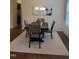 Dining room featuring wainscoting, wood floors, modern chandelier, and a neutral color palette at 243 Nortwick Rd, Rolesville, NC 27571