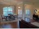 Inviting dining room with hardwood floors, white rug, and view of the entryway with glass doors at 243 Nortwick Rd, Rolesville, NC 27571