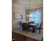 Dining room featuring wainscoting, wood floors, modern chandelier, and a neutral color palette at 243 Nortwick Rd, Rolesville, NC 27571