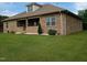 Brick home with a covered patio and well maintained lawn with white gravel at 243 Nortwick Rd, Rolesville, NC 27571